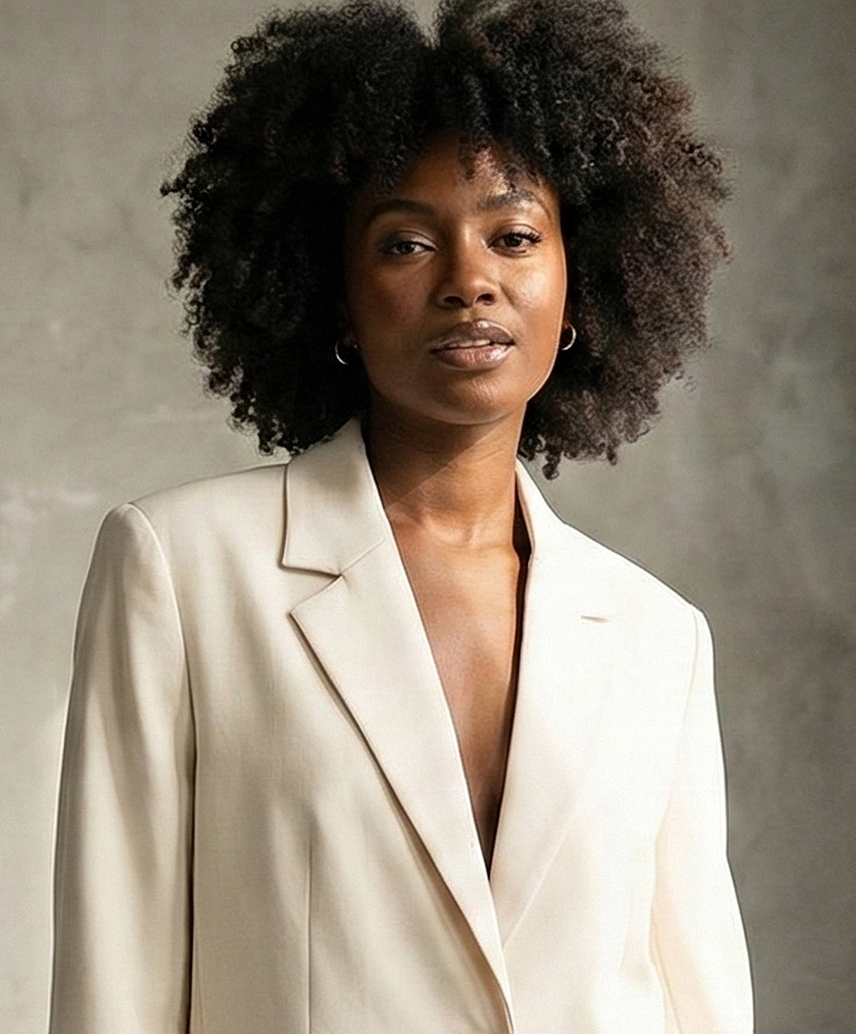 Model posing with hands raised and closed eyes.