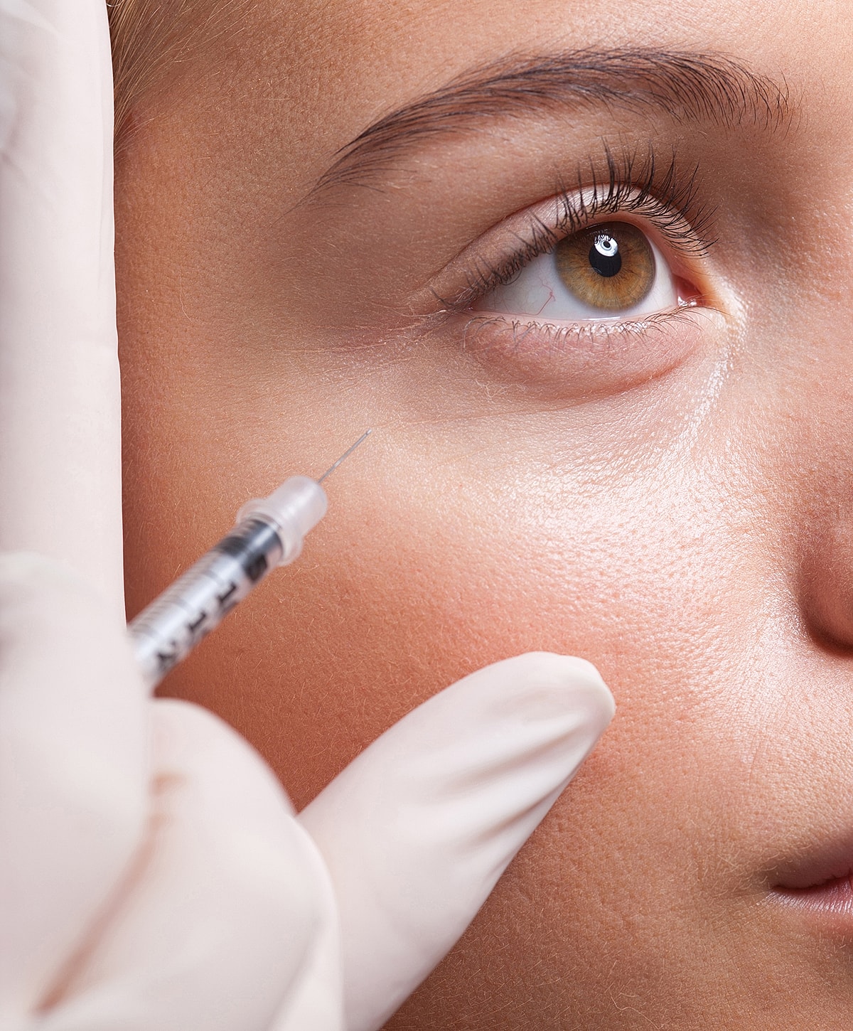Model posing with hands raised and closed eyes.