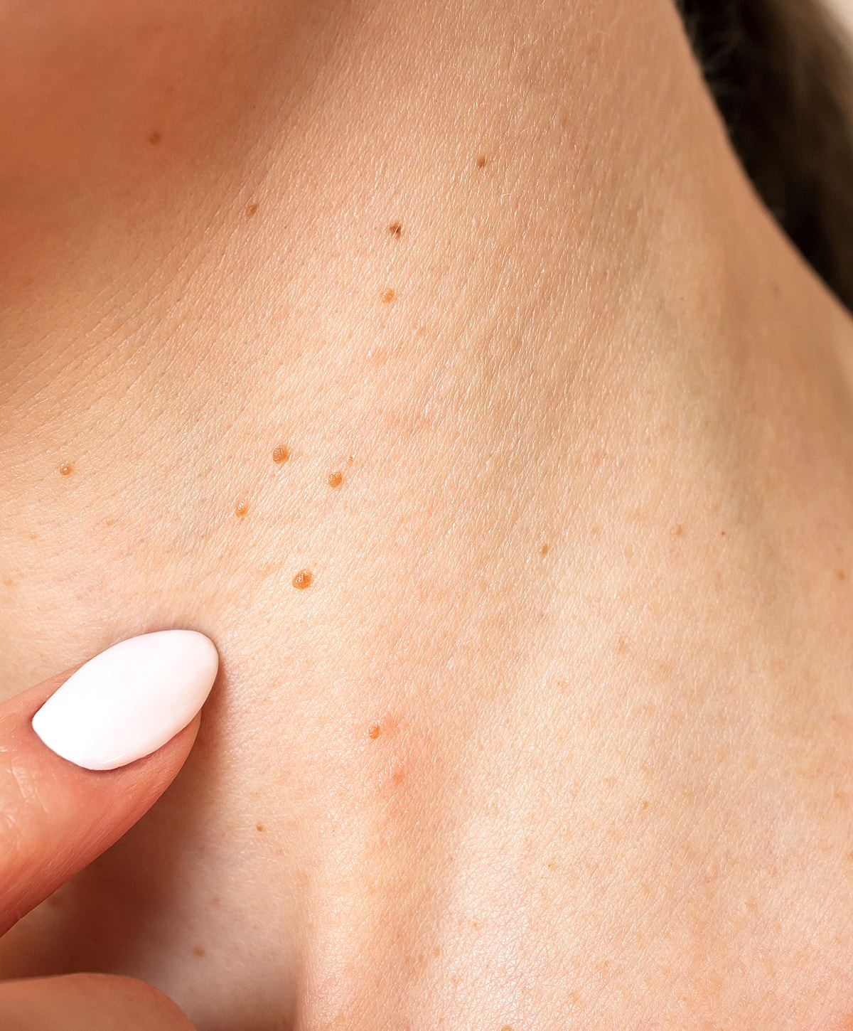 Model posing with hands raised and closed eyes.