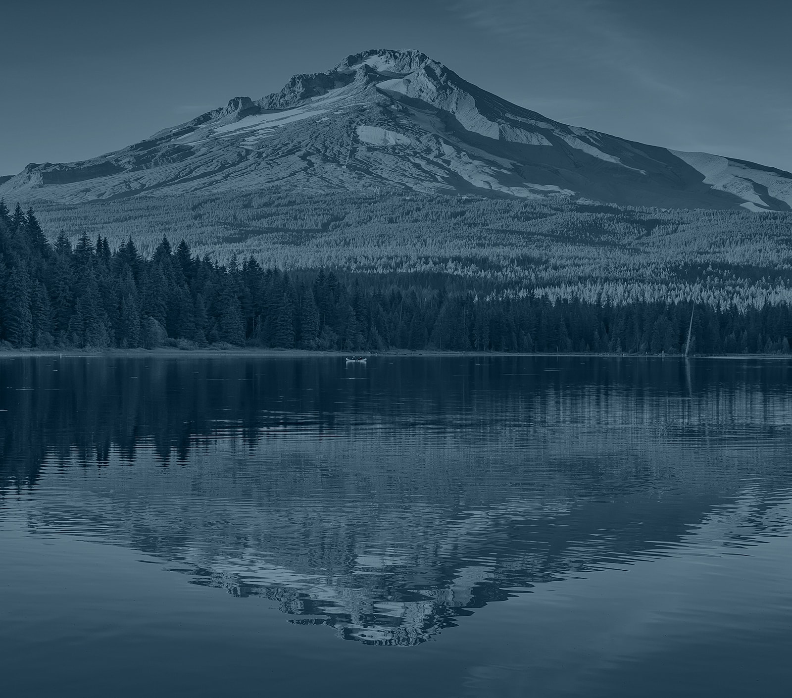 Mountain reflection in calm lake water.