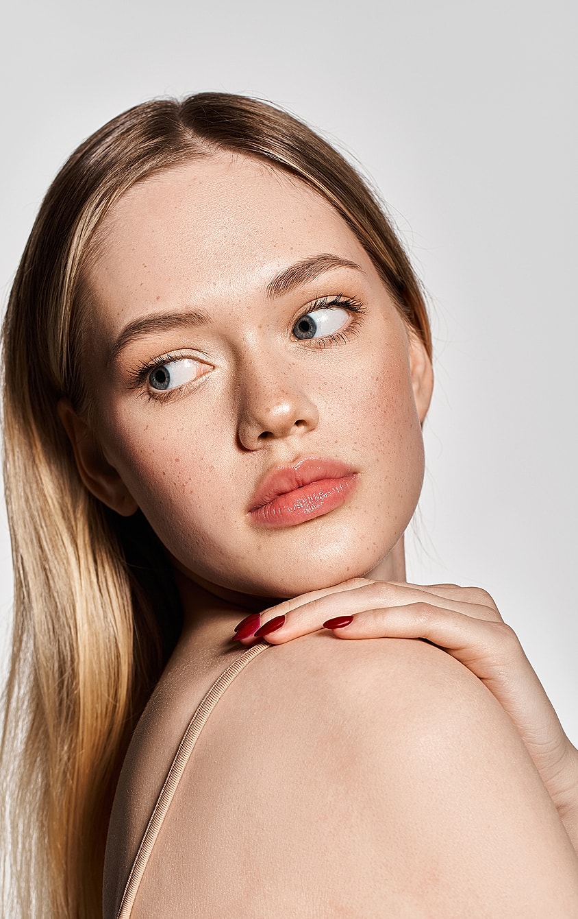 Model showcasing elegant jewelry and stylish attire.