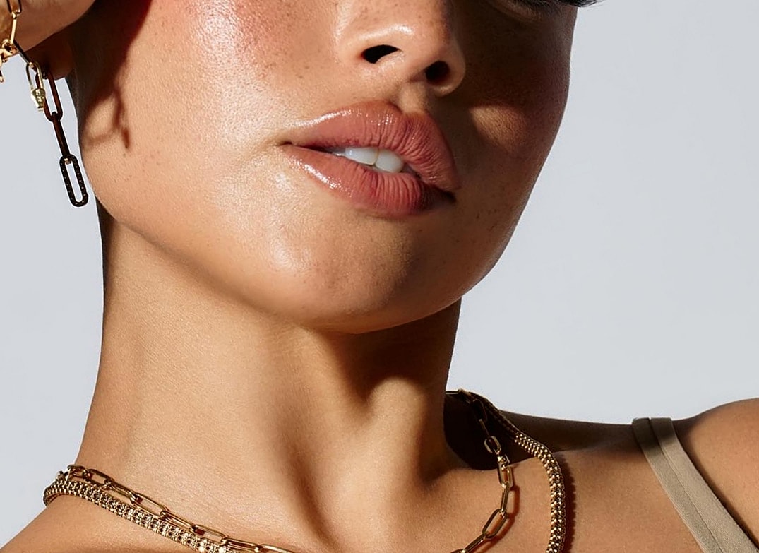 Portrait of a woman with long hair and freckles.